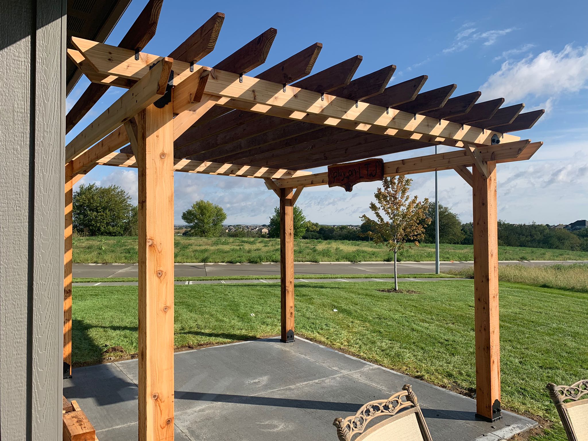 Outdoor pergola with grassy backdrop