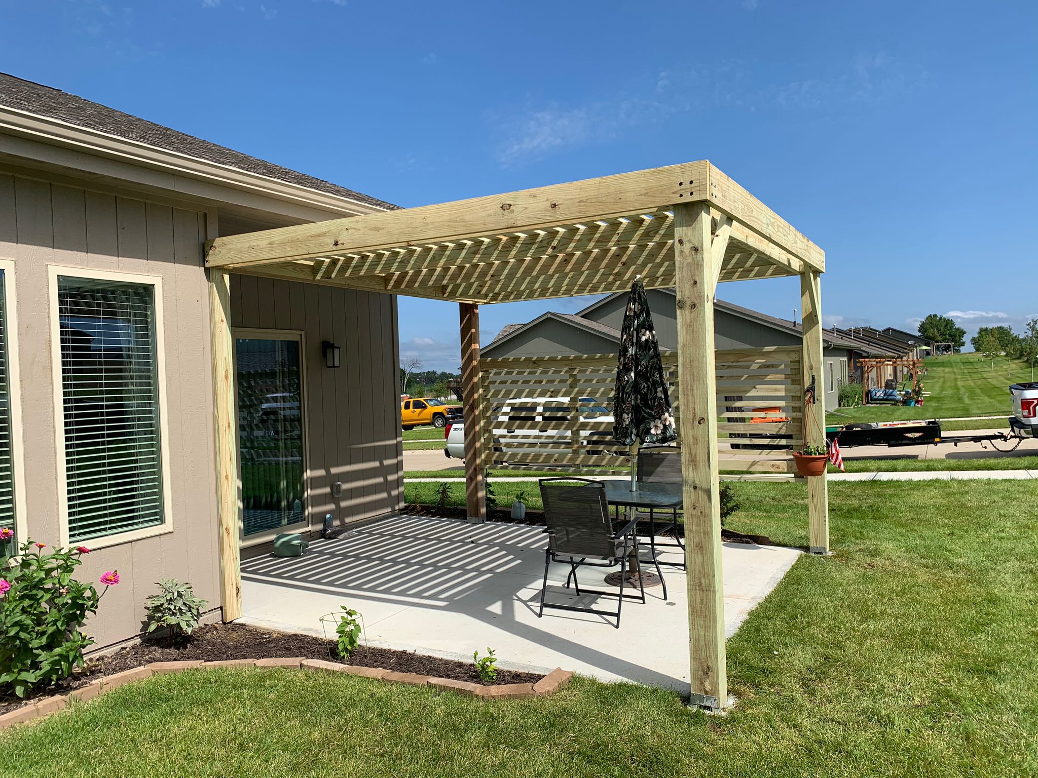 Backyard patio with wooden pergola