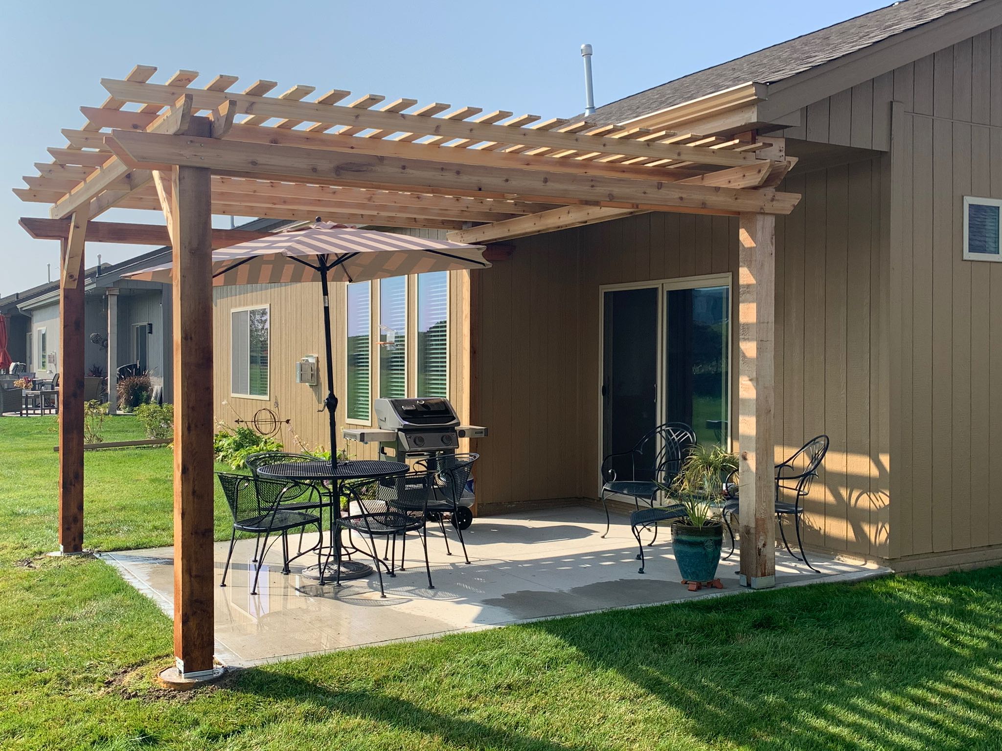 Outdoor seating area under wooden pergola