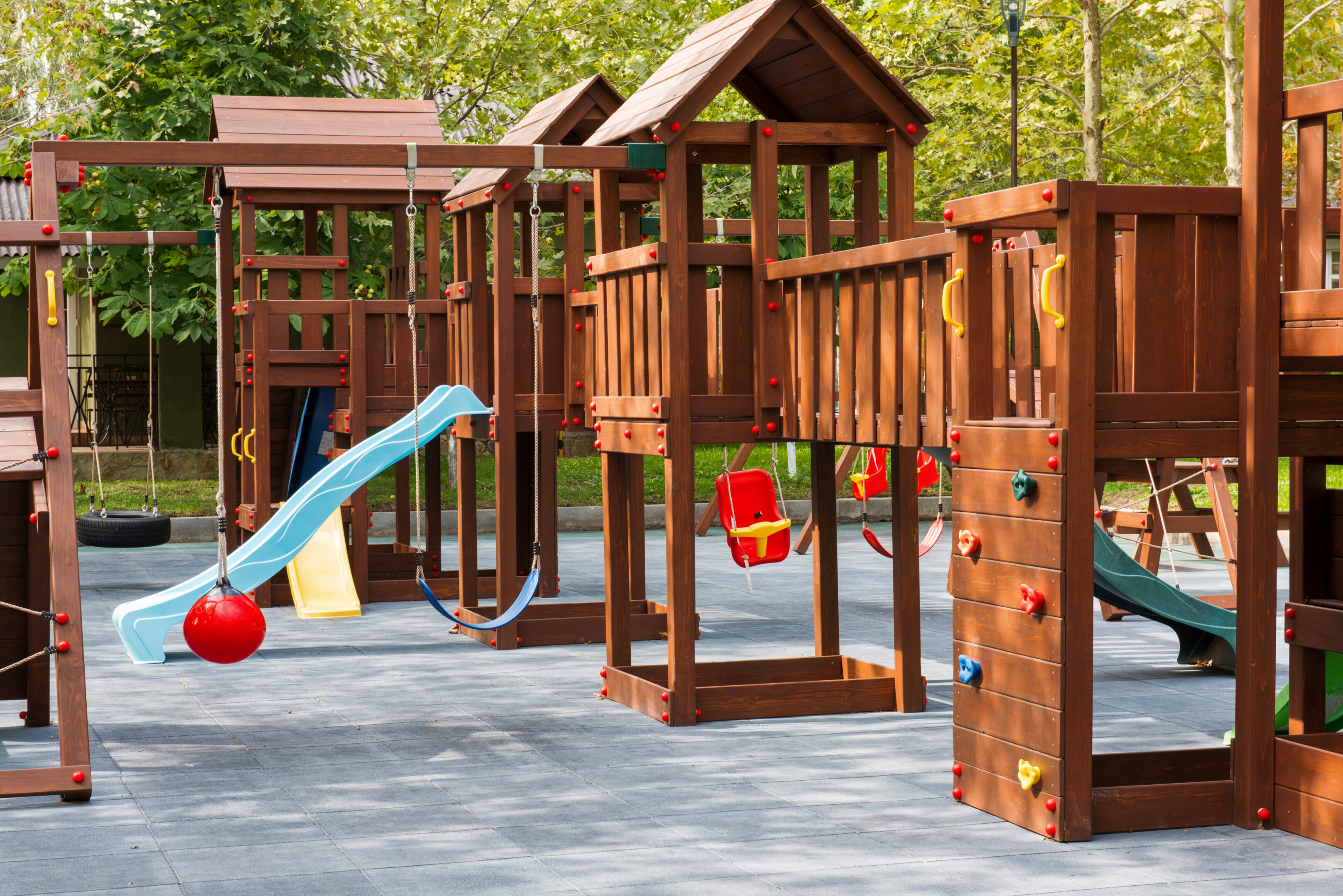 Wooden playground with slides and swings