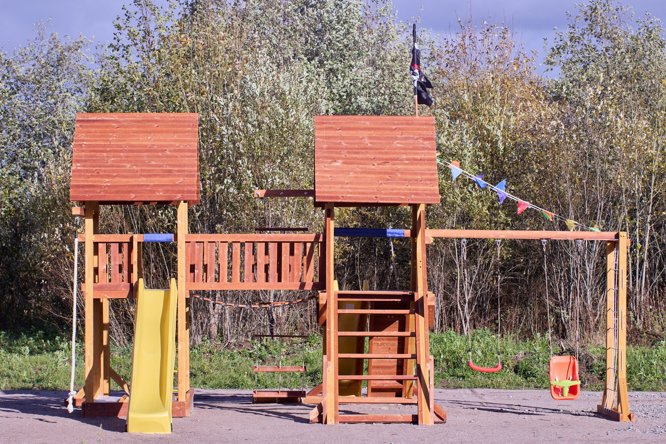Wooden playground set with slide and swings
