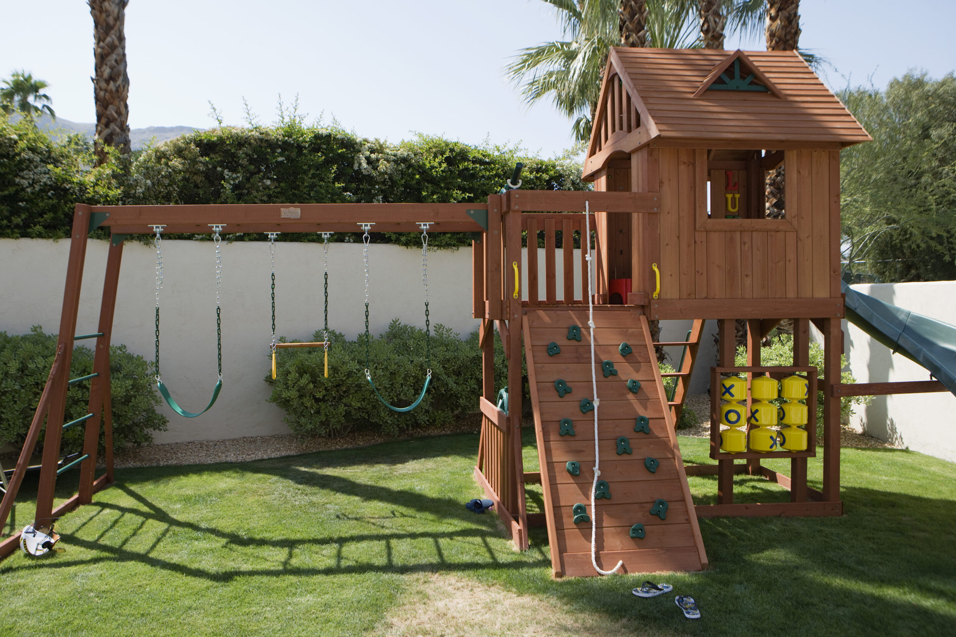 Wooden playset with swings and slide